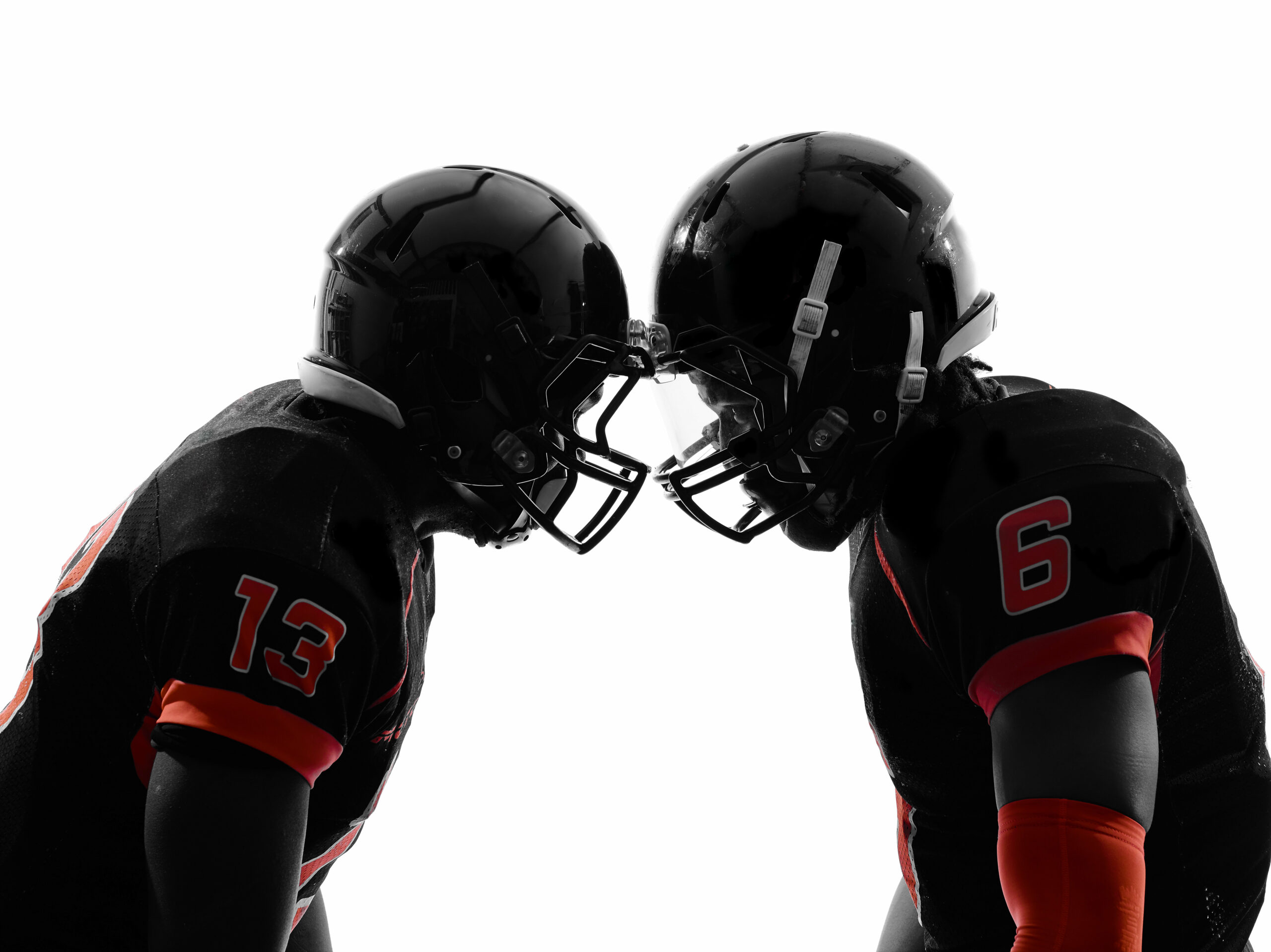 two american football players face to face in silhouette shadow on white background